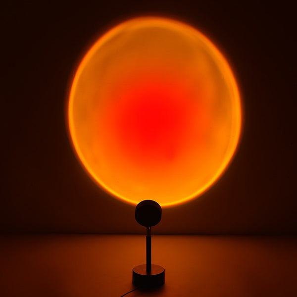 The Dusk Lamp casting a warm sunset glow on a wall